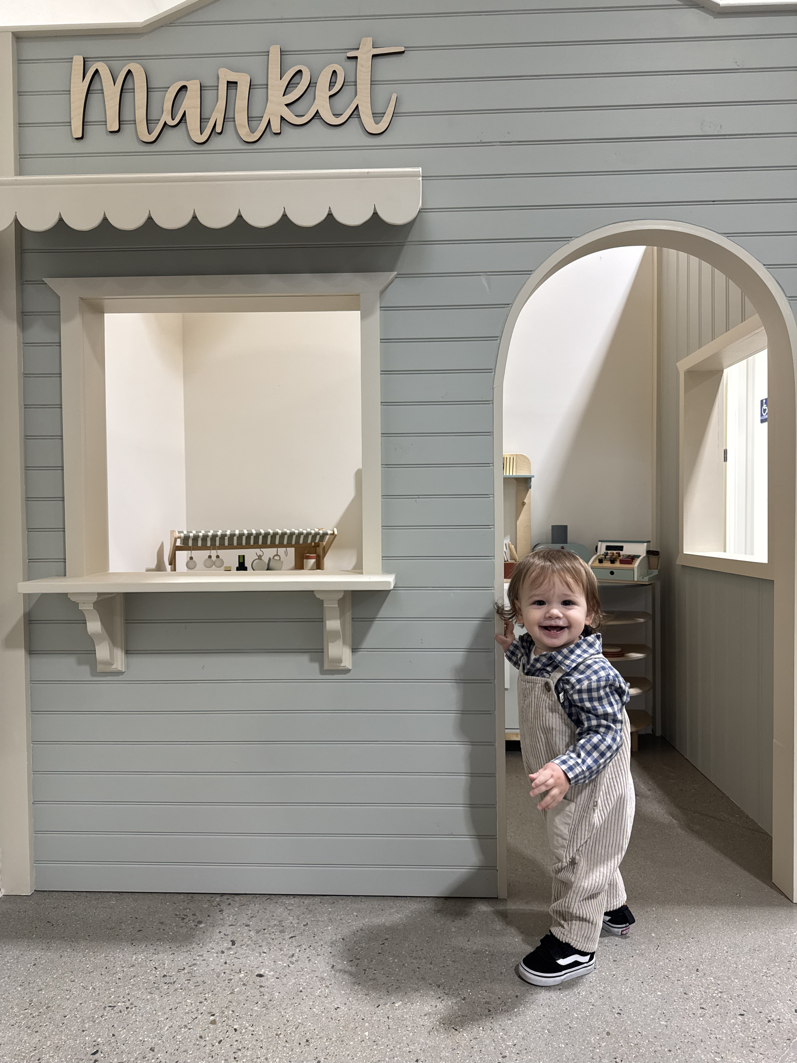 A little one standing in The Foundry's children's market play area